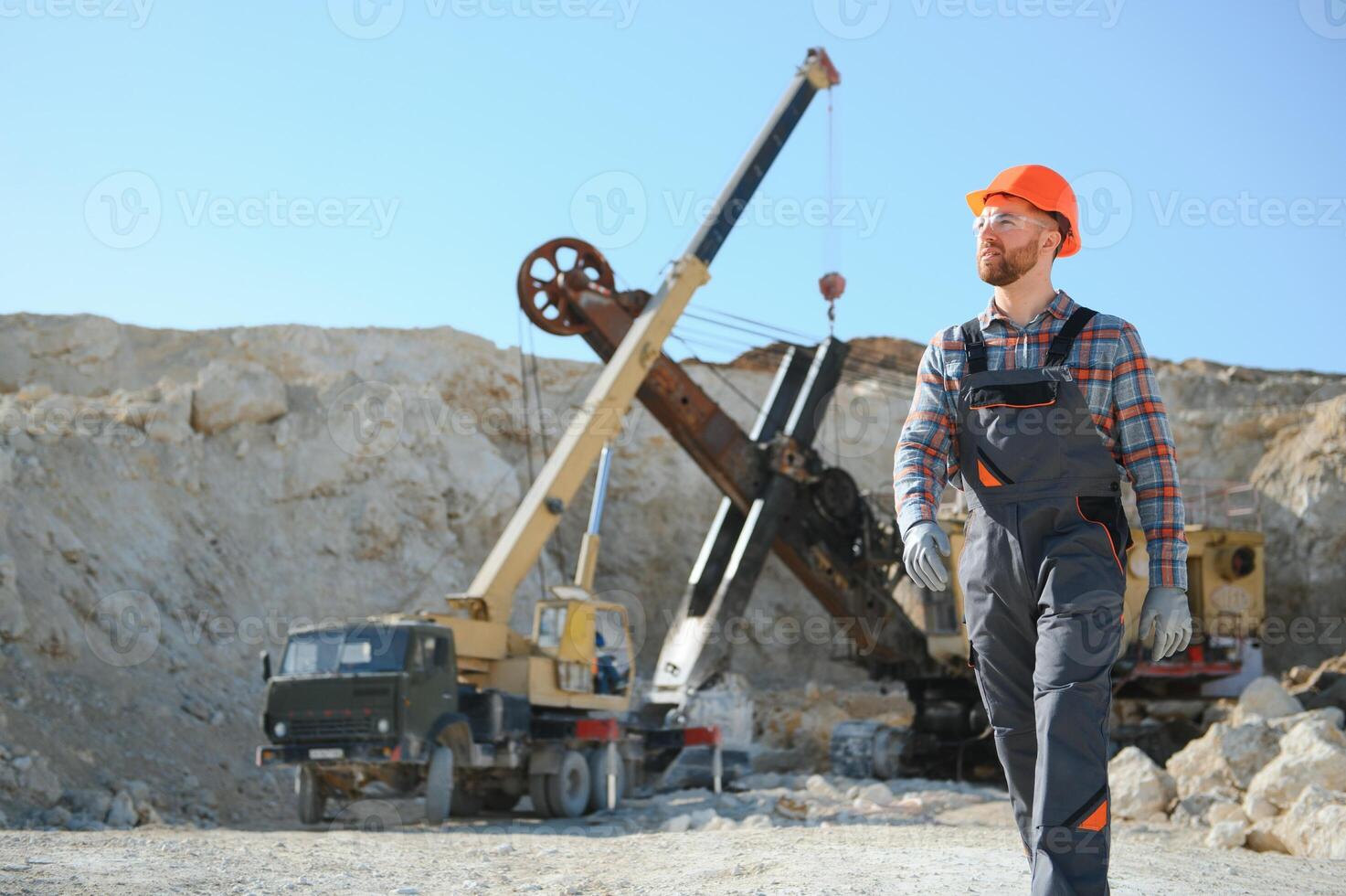Worker and quarry in background photo