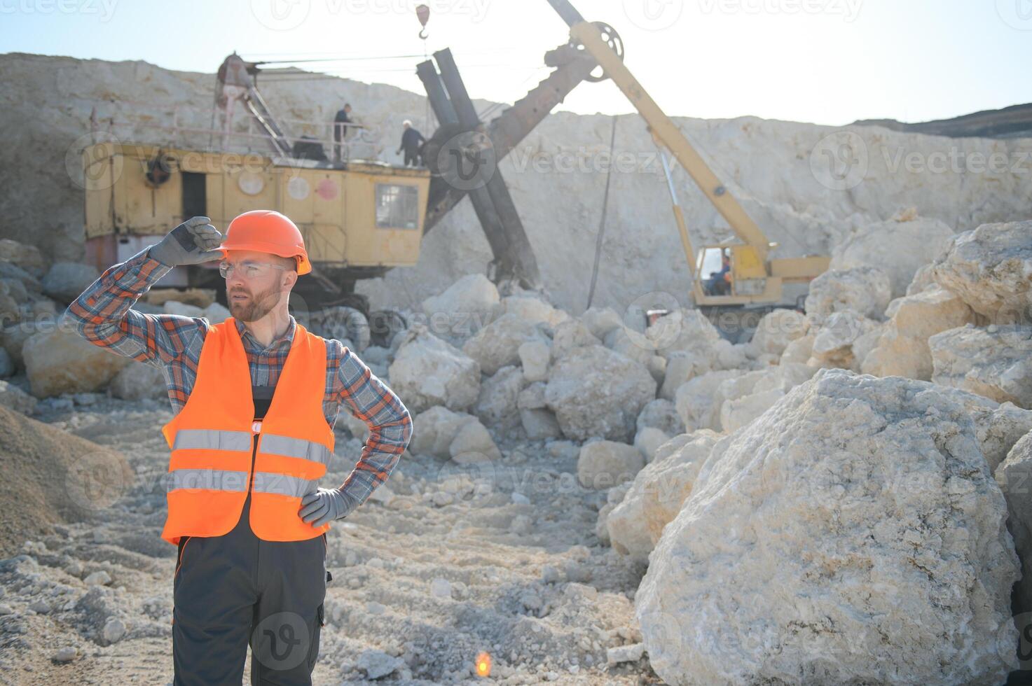 Portrait of a worker standing on the background of a stone quarry photo
