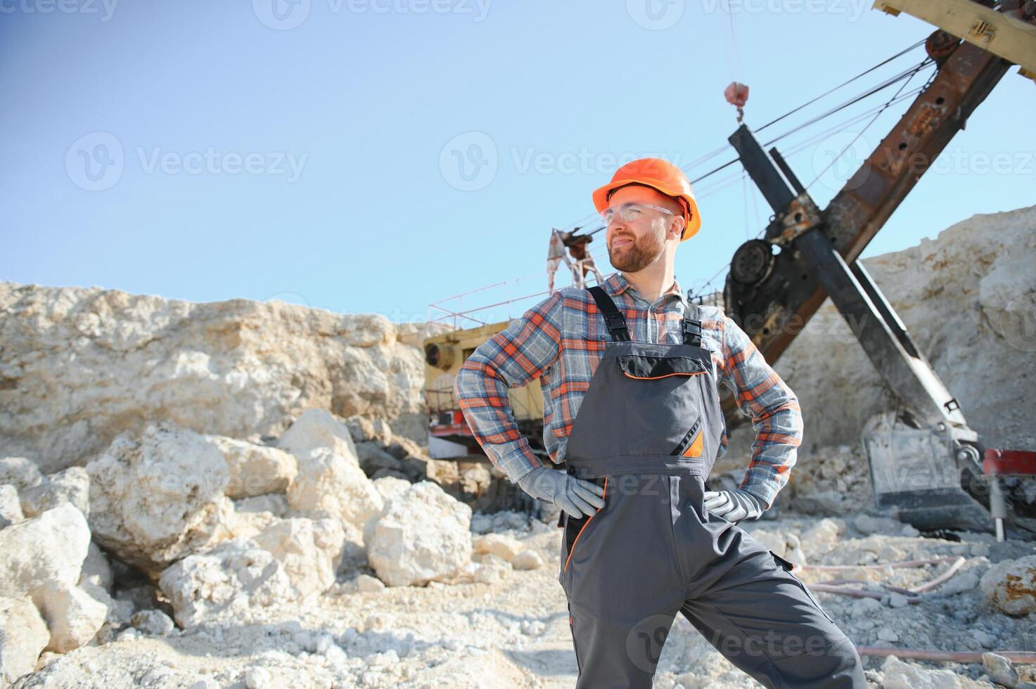 Male worker with bulldozer in sand quarry photo