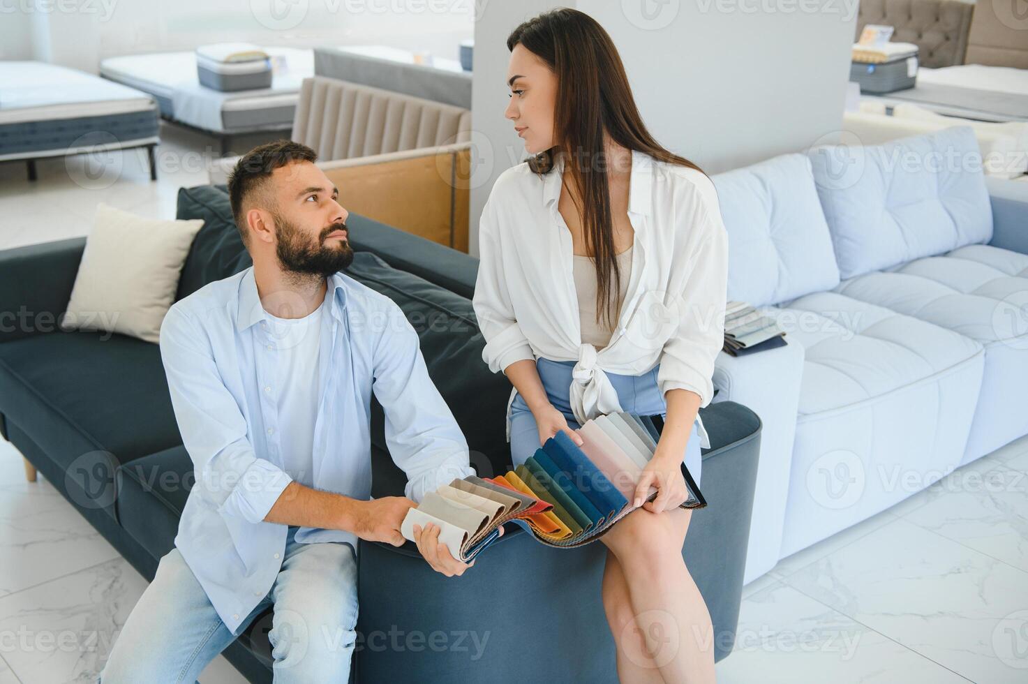 Married couple chooses the best new sofa in a furniture store photo