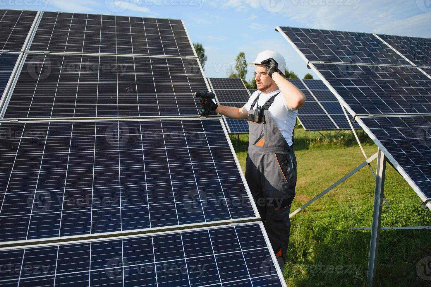 Worker installing solar panels outdoors photo