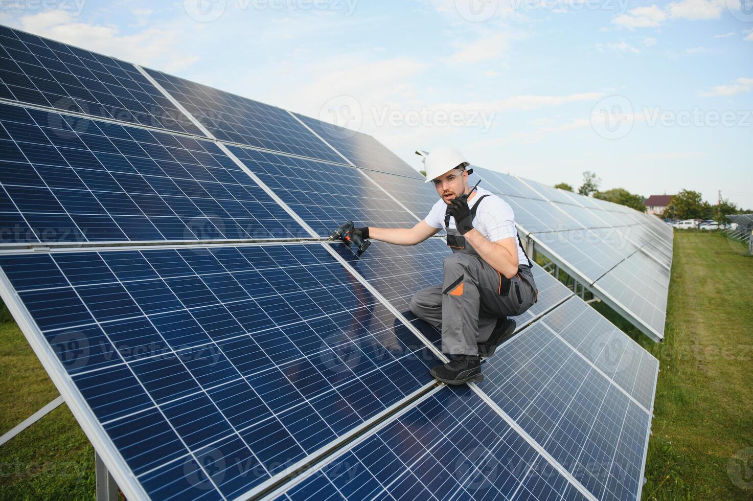 Worker installing solar panels outdoors photo