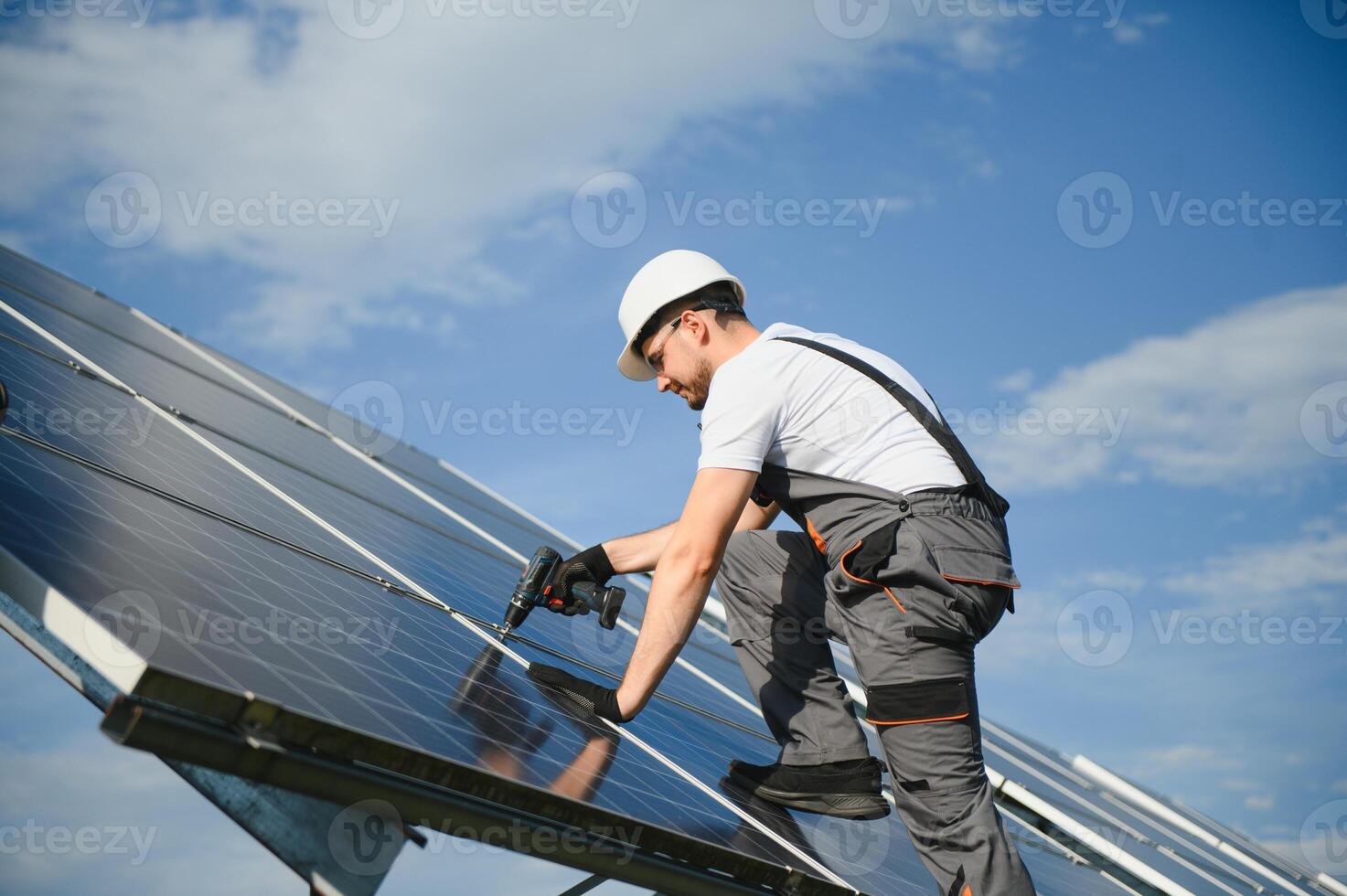 Worker installing solar panels outdoors photo