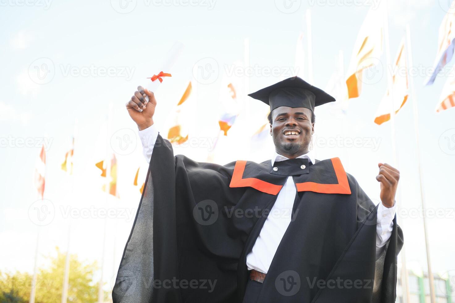 smiling african american graduated student showing diploma photo