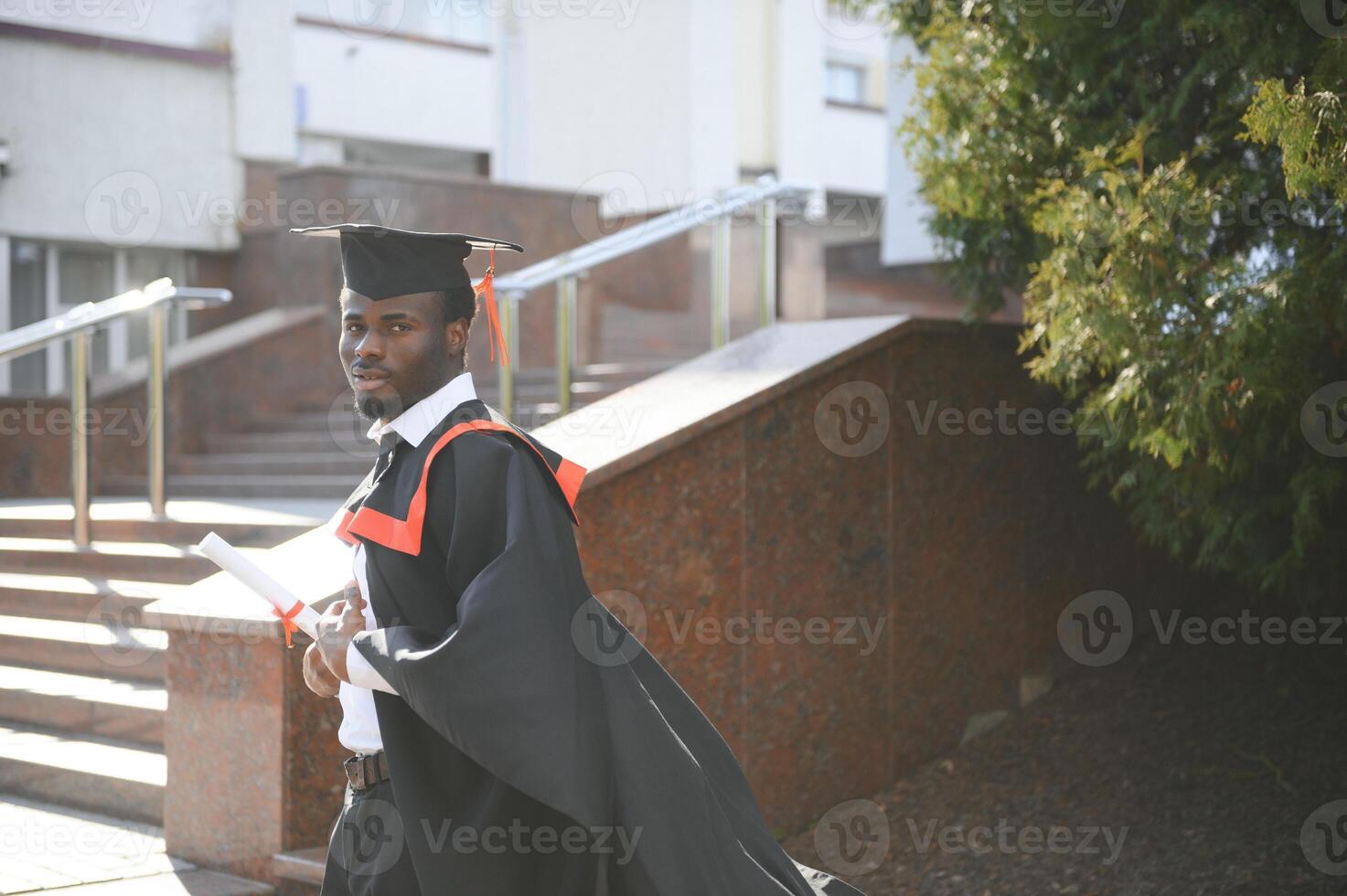 Happy graduate. Happy African man in graduation gowns photo