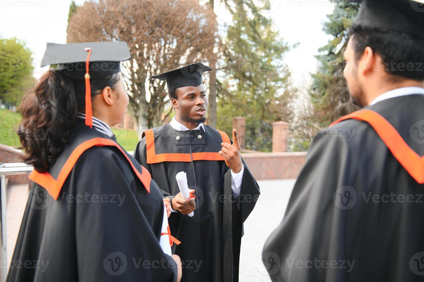 Diverse international students with diplomas attending graduation ceremony, happy multiracial group of students photo