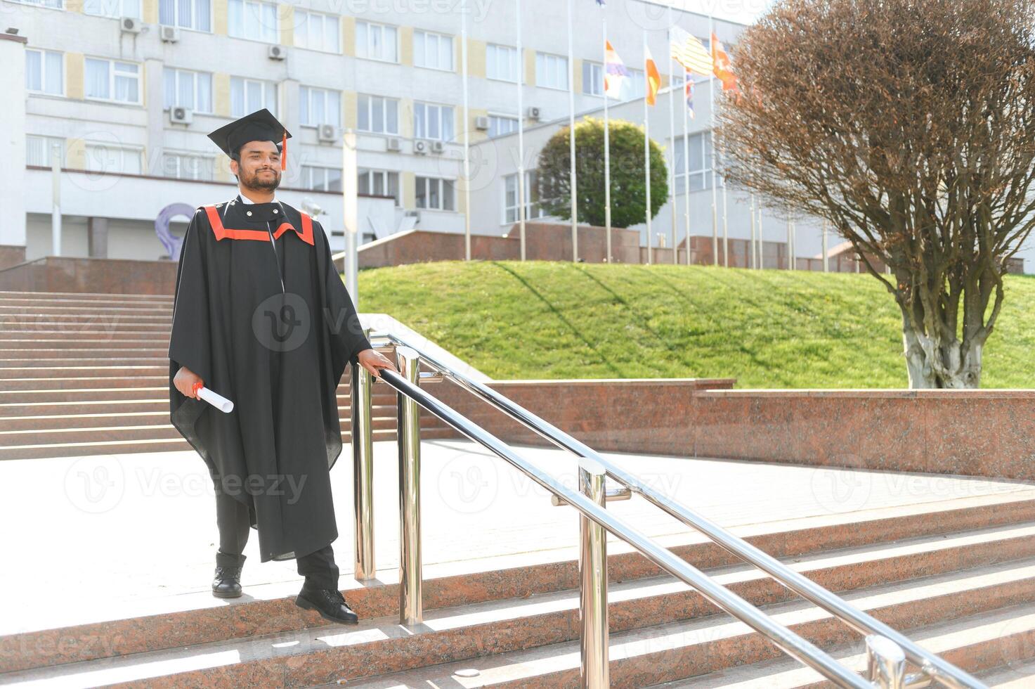 Portrait of happy man, graduation or student in university campus photo