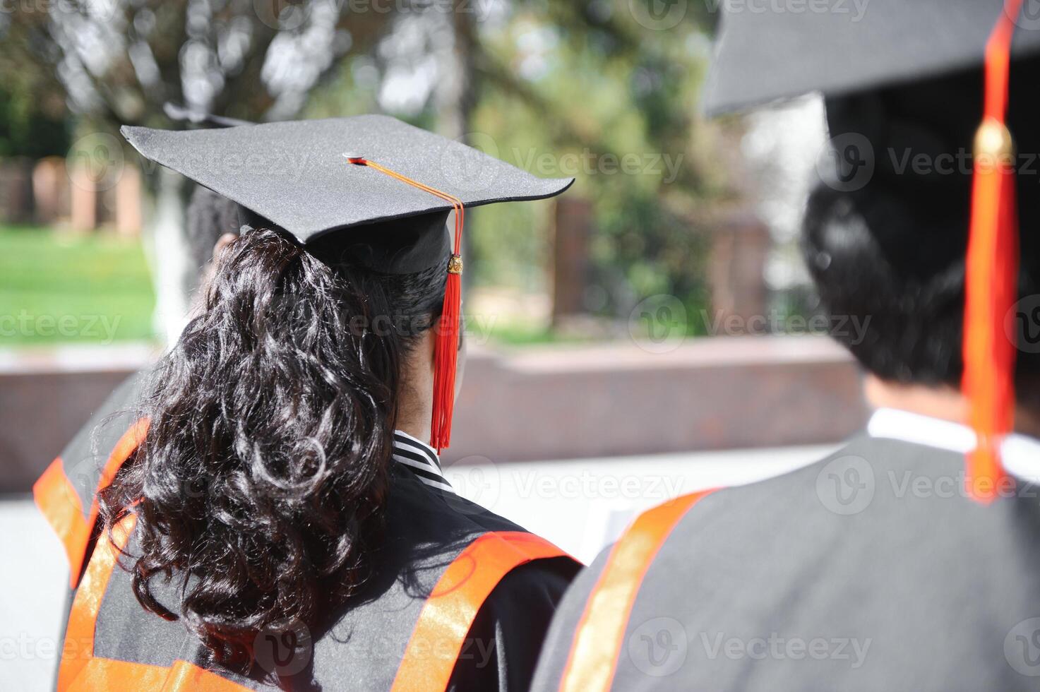 education, graduation and people concept - group of happy international students in mortar boards and bachelor gowns with diplomas photo