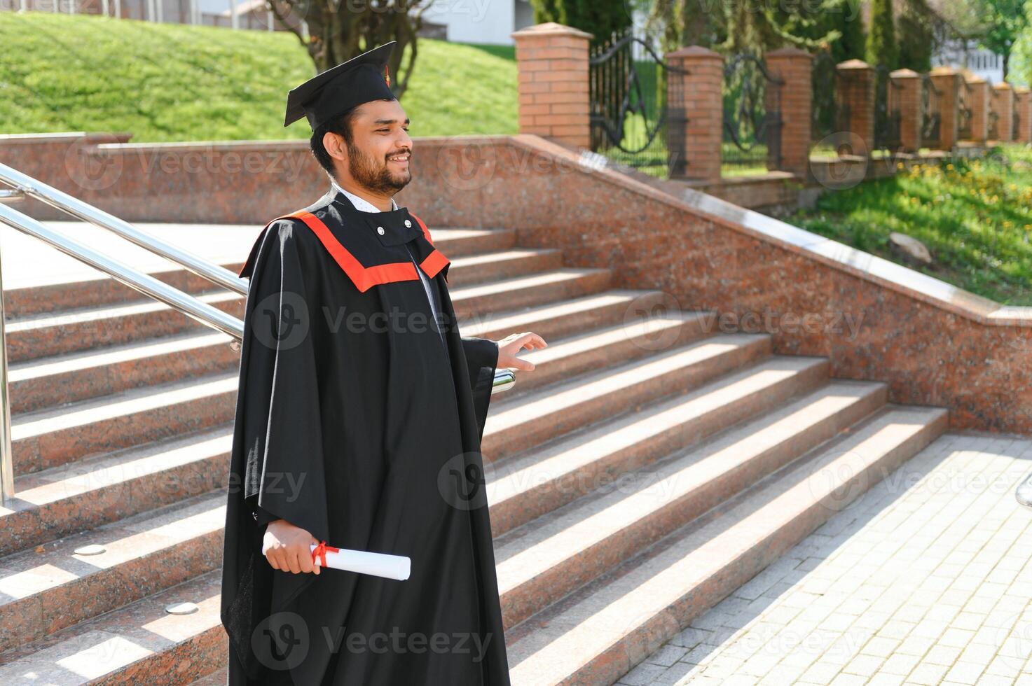 Portrait of happy man, graduation or student in university campus photo