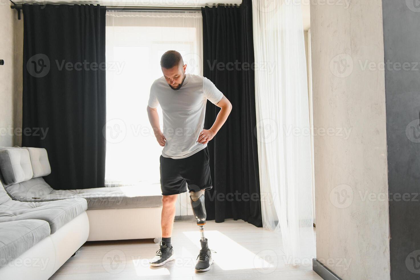 Man amputee with prosthetic leg disability on above knee transfemoral leg prosthesis artificial device, close up. People with amputation disabilities everyday life photo