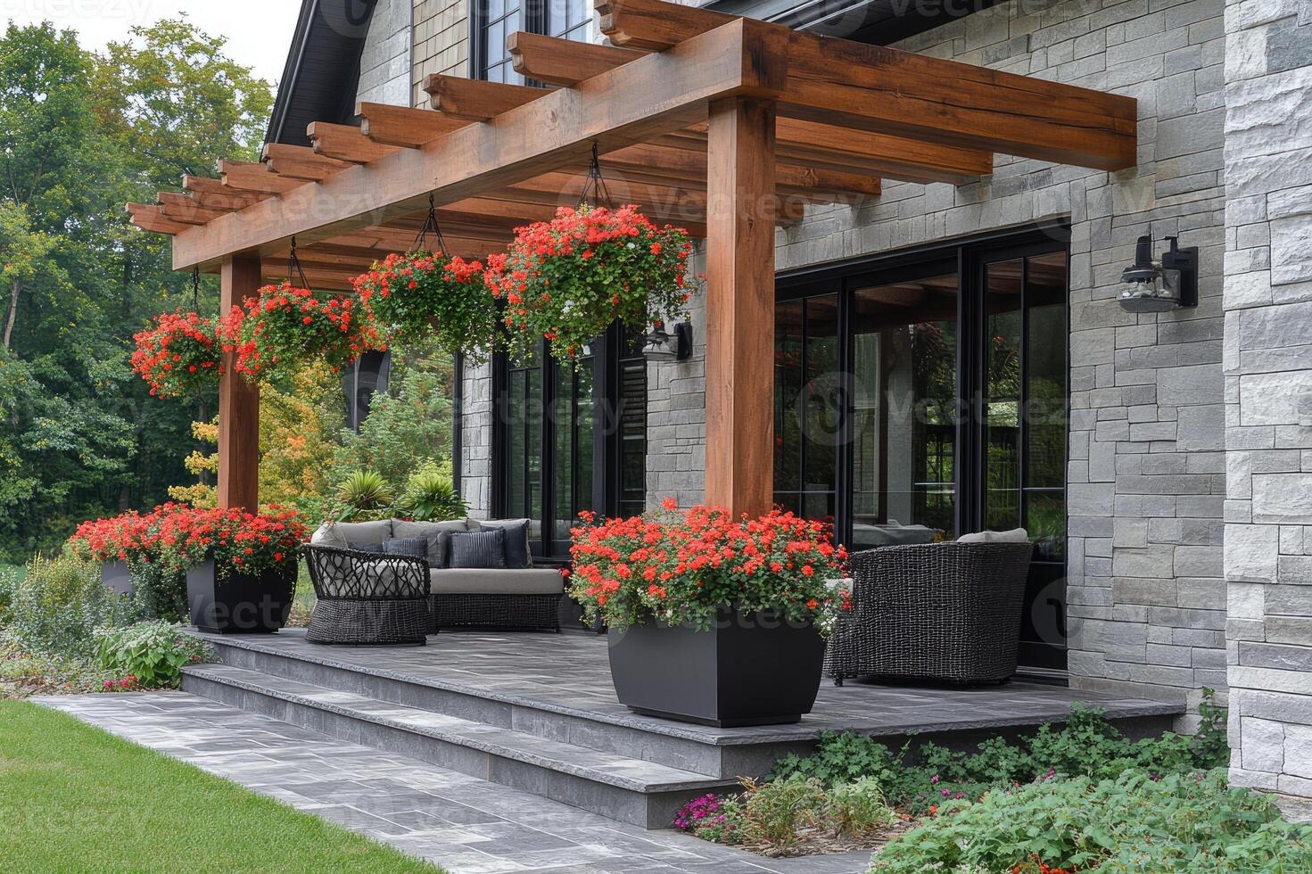 Beautiful covered patio with hanging flower baskets decorating a white brick house photo