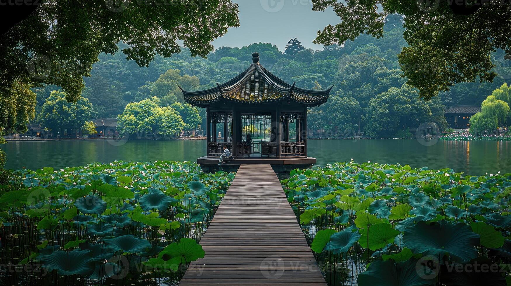 Wooden pathway leading to a pavilion on a lake in a public park with lush vegetation photo