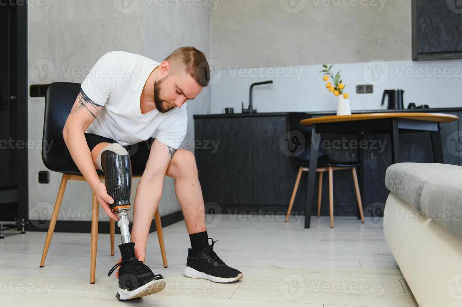 Man amputee with prosthetic leg disability on above knee transfemoral leg prosthesis artificial device, close up. People with amputation disabilities everyday life photo