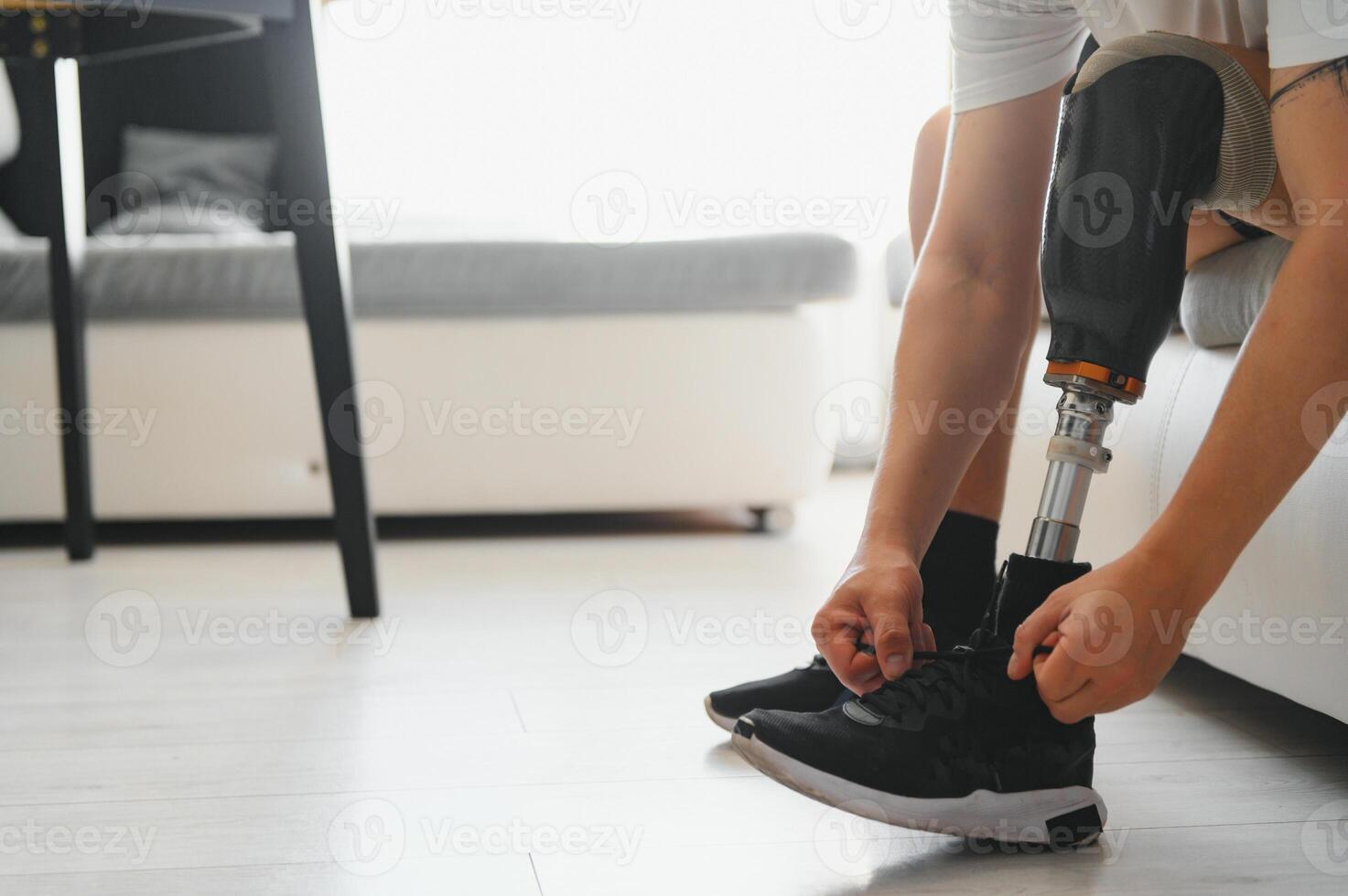portrait of man with prosthetic leg sitting photo