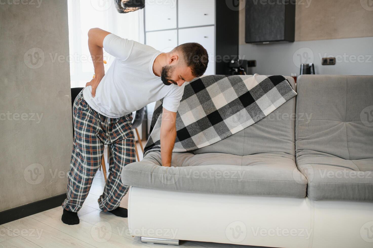 Back pain, kidney inflammation, man suffering from backache at home, health problems concept photo