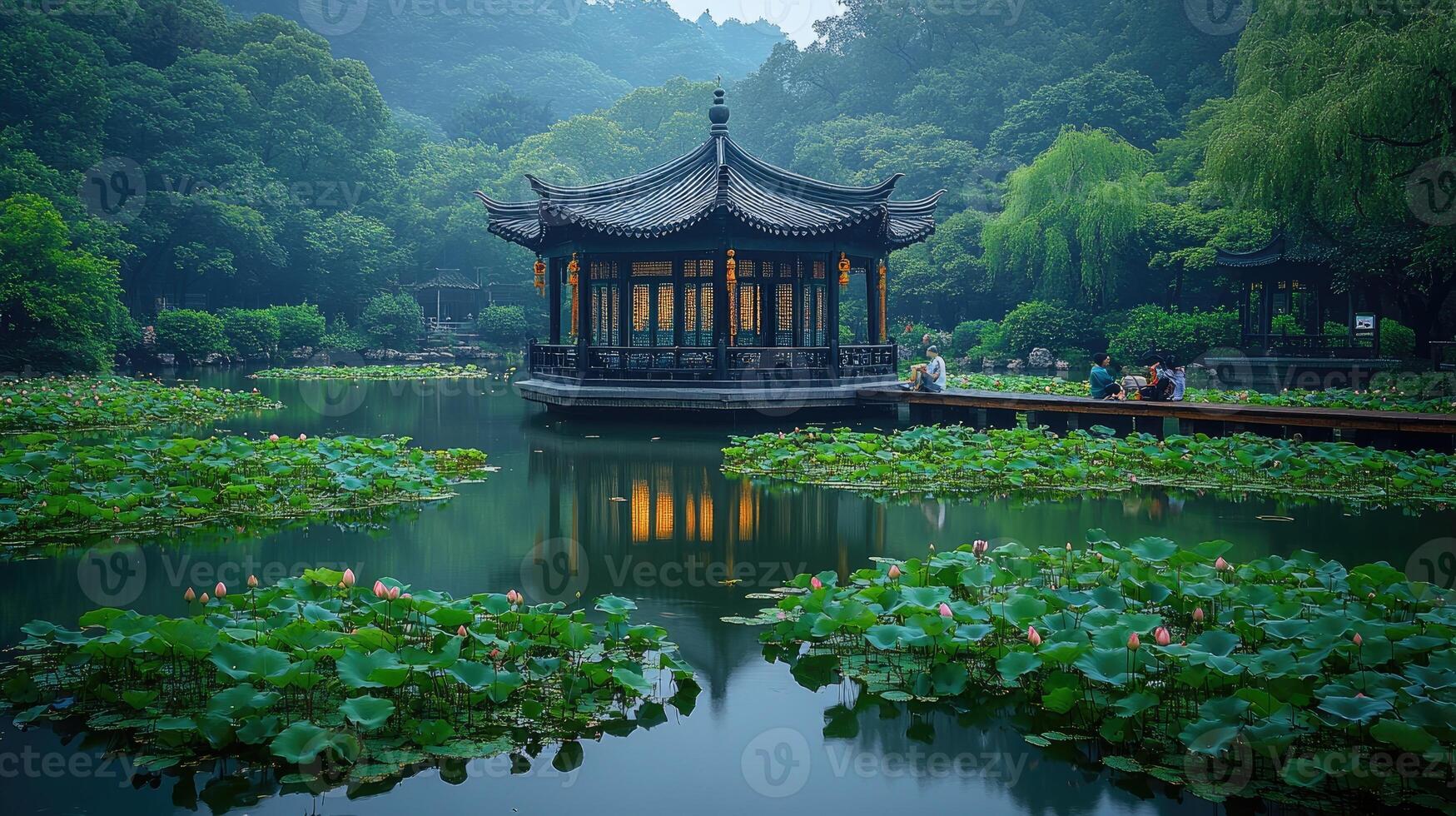 Wooden pathway leading to a pavilion on a lake in a public park with lush vegetation photo