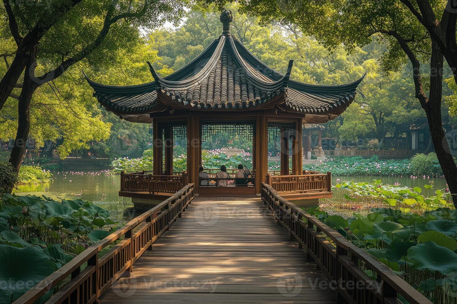 Wooden pathway leading to a pavilion on a lake in a public park with lush vegetation photo