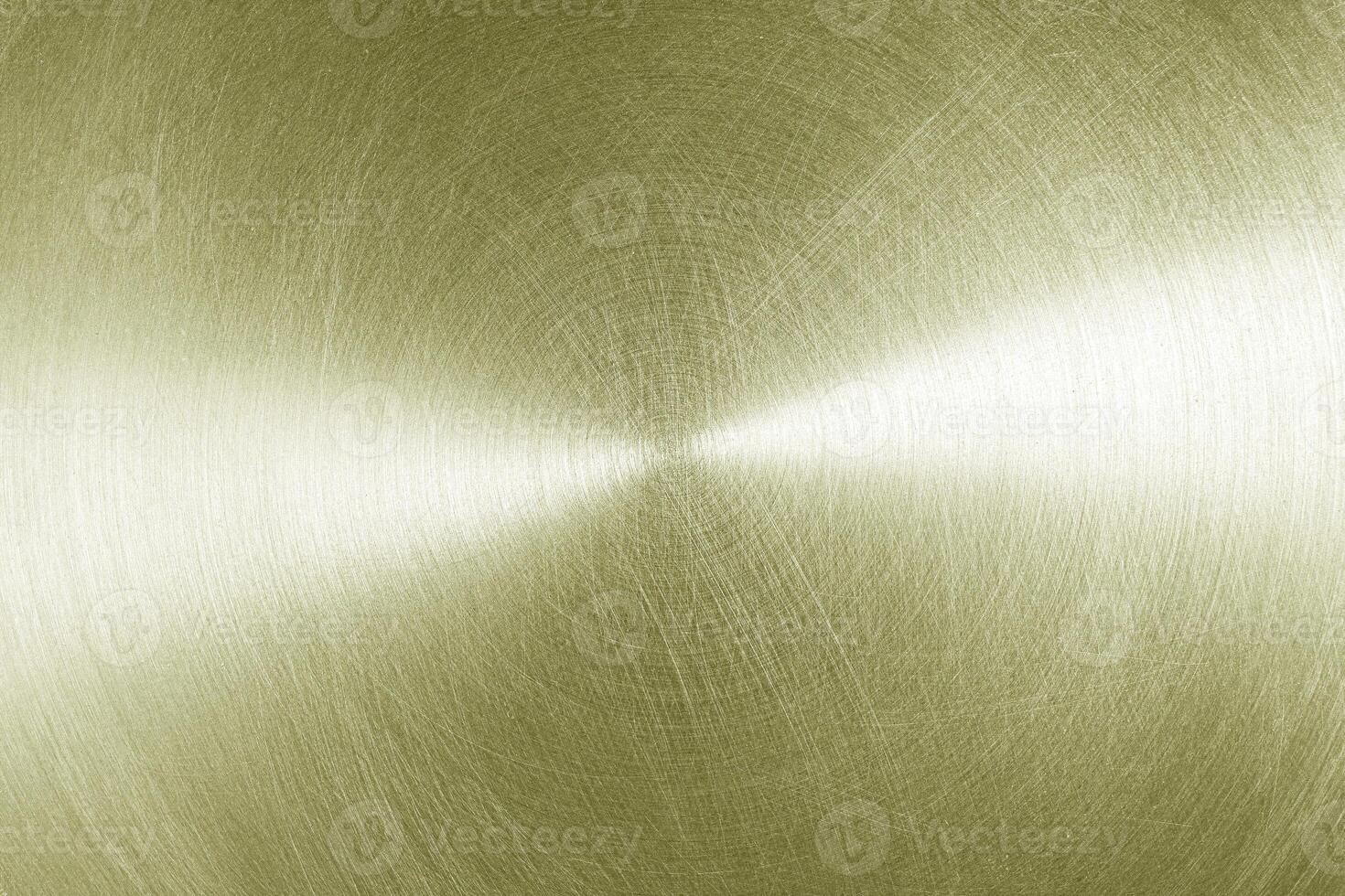 Golden circular brushed shiny metal texture. Abstract metallic background. Circle shape. photo