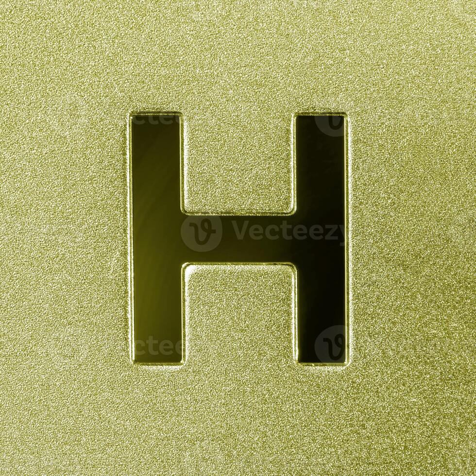 Letter H on a golden grained shiny metal surface. English alphabet. photo