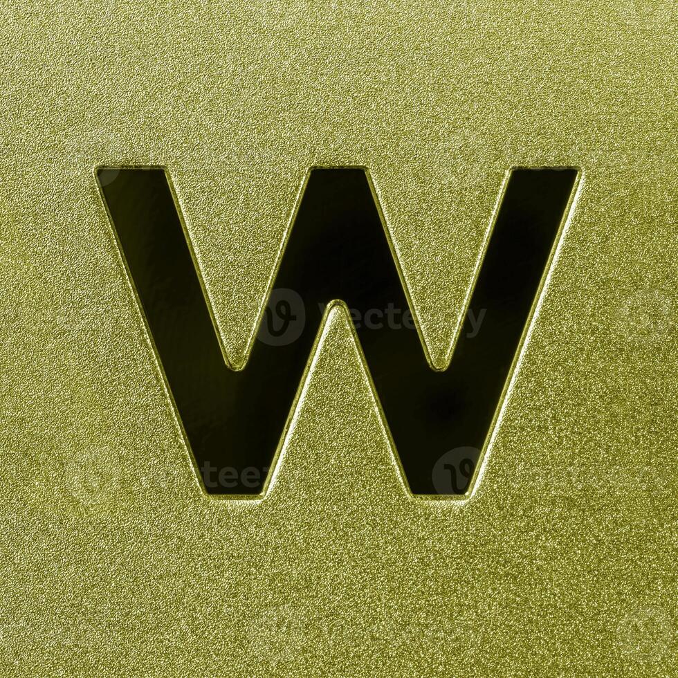 Letter W on a golden grained shiny metal surface. English alphabet. photo