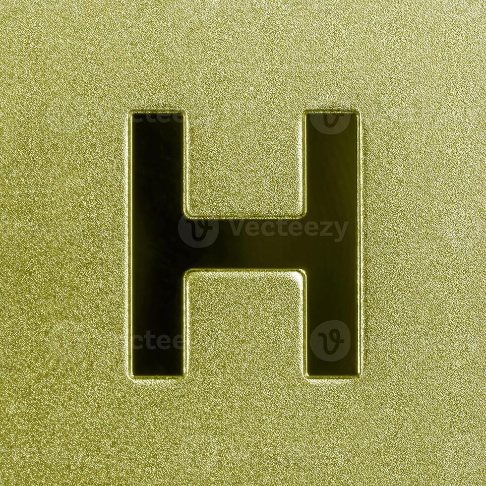 Letter H on a golden grained shiny metal surface. English alphabet. photo
