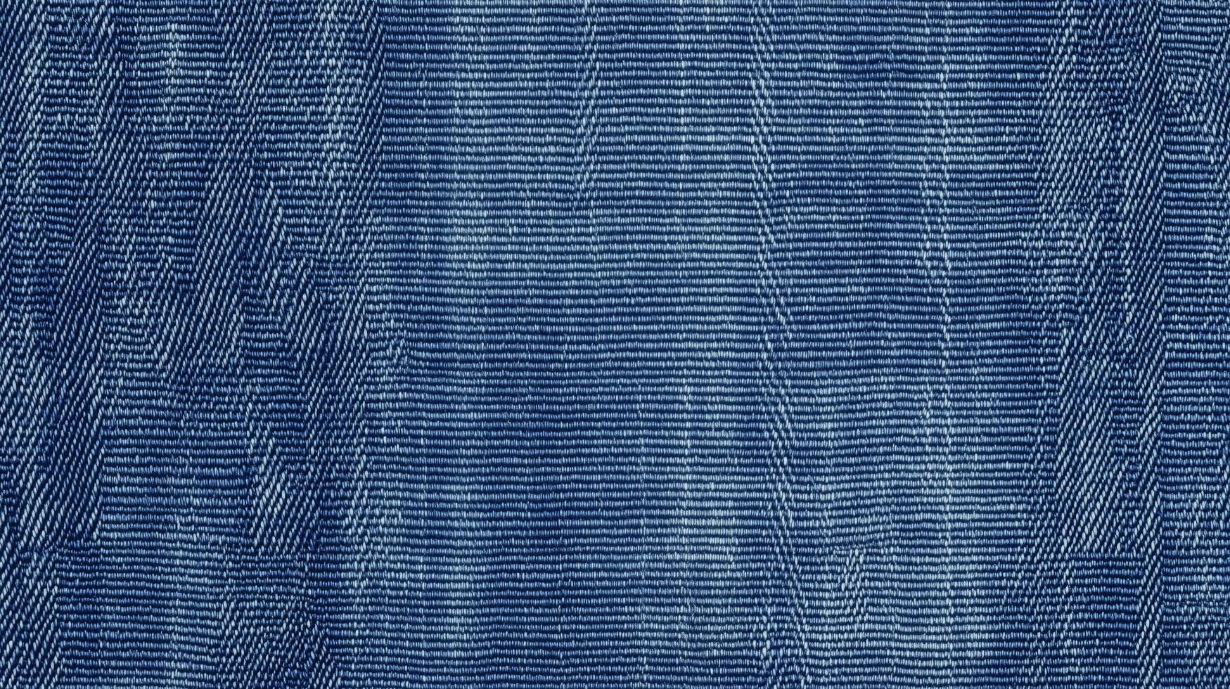 A blue denim fabric with a zigzag pattern. The fabric is blue and has a rough texture. photo