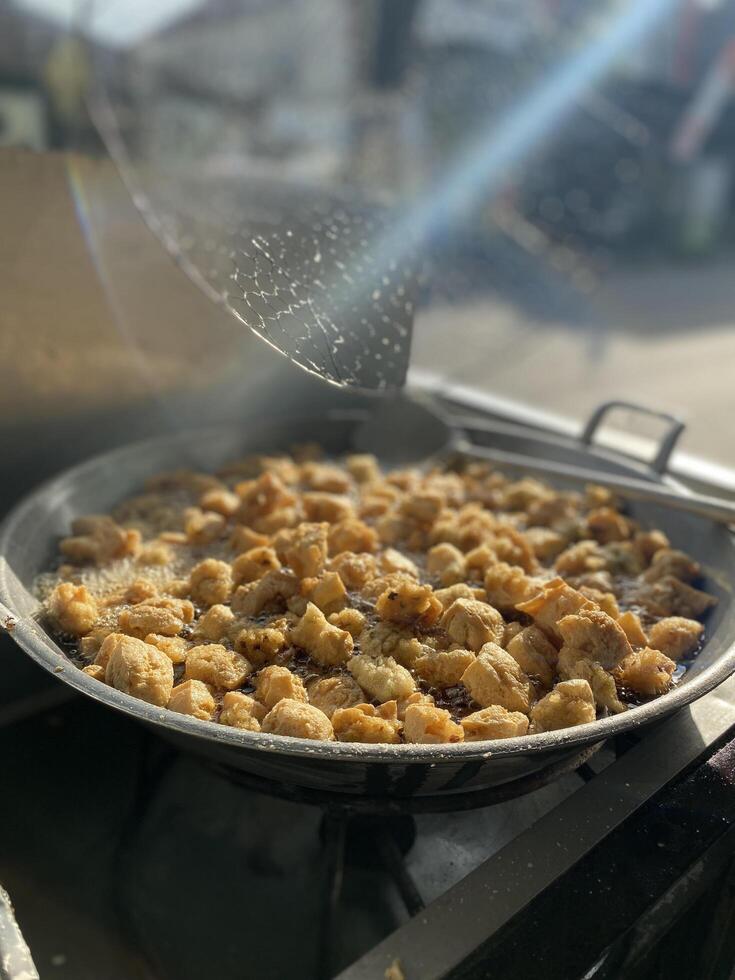 Fried tofu meatballs in a frying pan with a blurred background photo