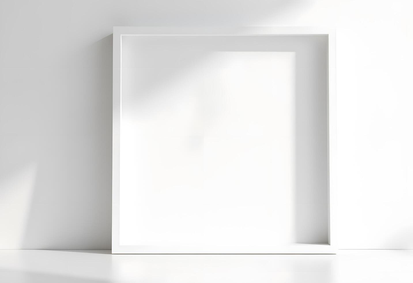 Empty white frame on a white wall photo
