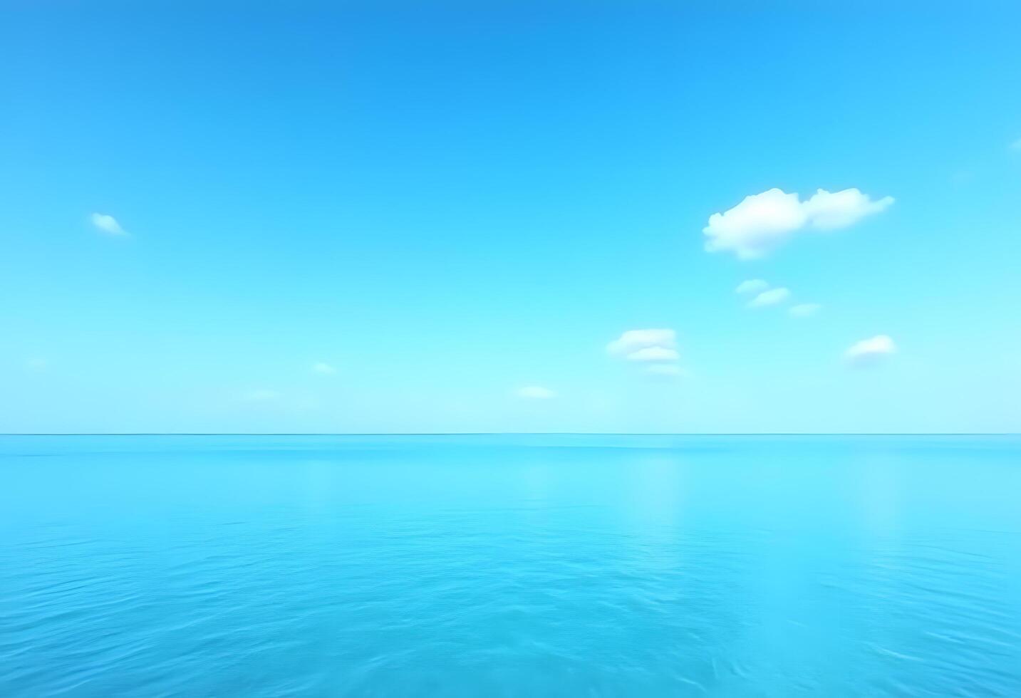 A blue ocean with clouds and a sky photo