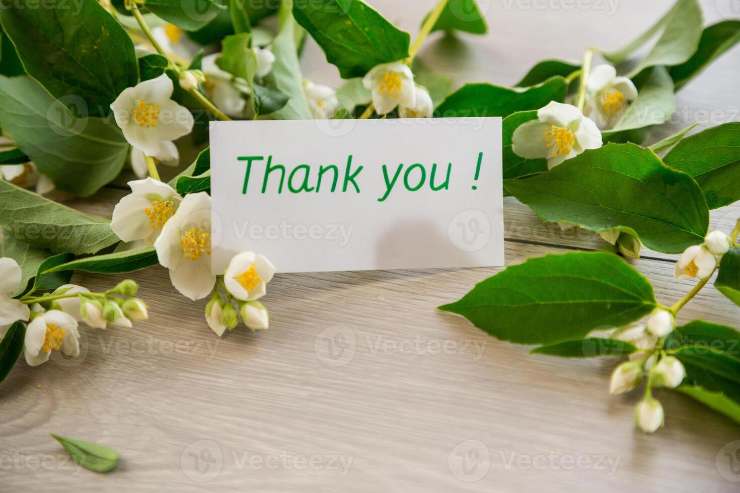 wooden light background with white jasmine flowers photo