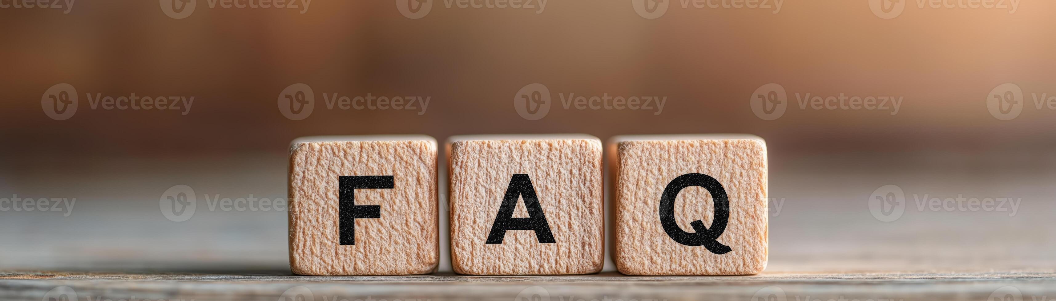 Close-up of wooden blocks displaying the letters FAQ, representing frequently asked questions. Perfect for customer service or information-related imagery. photo