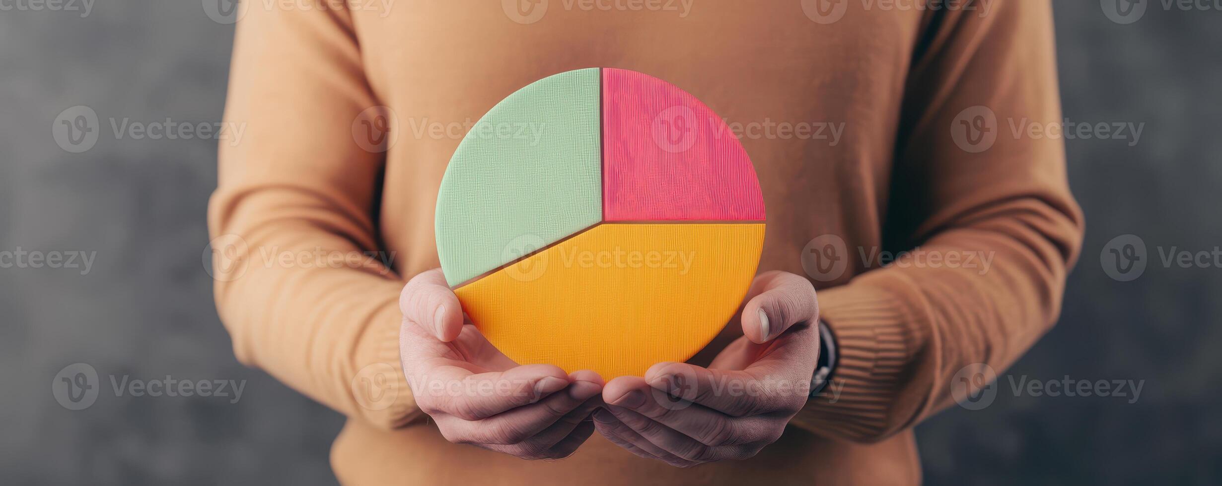 A person holding a colorful pie chart, representing data visualization and business statistics in a modern setting. photo