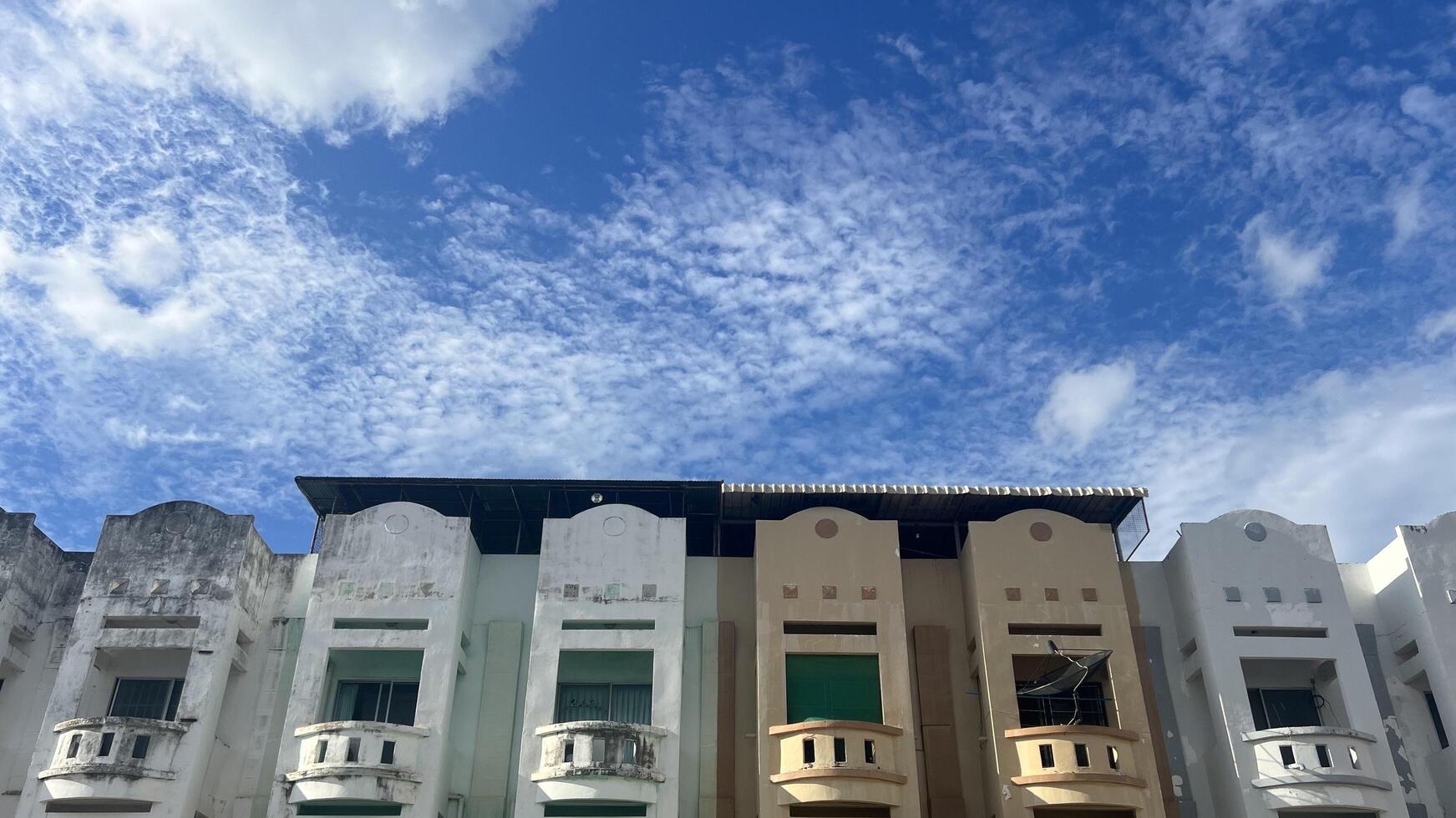 Old town buildings under a vibrant blue sky with clouds. Perfect for architecture and urban photography themes photo