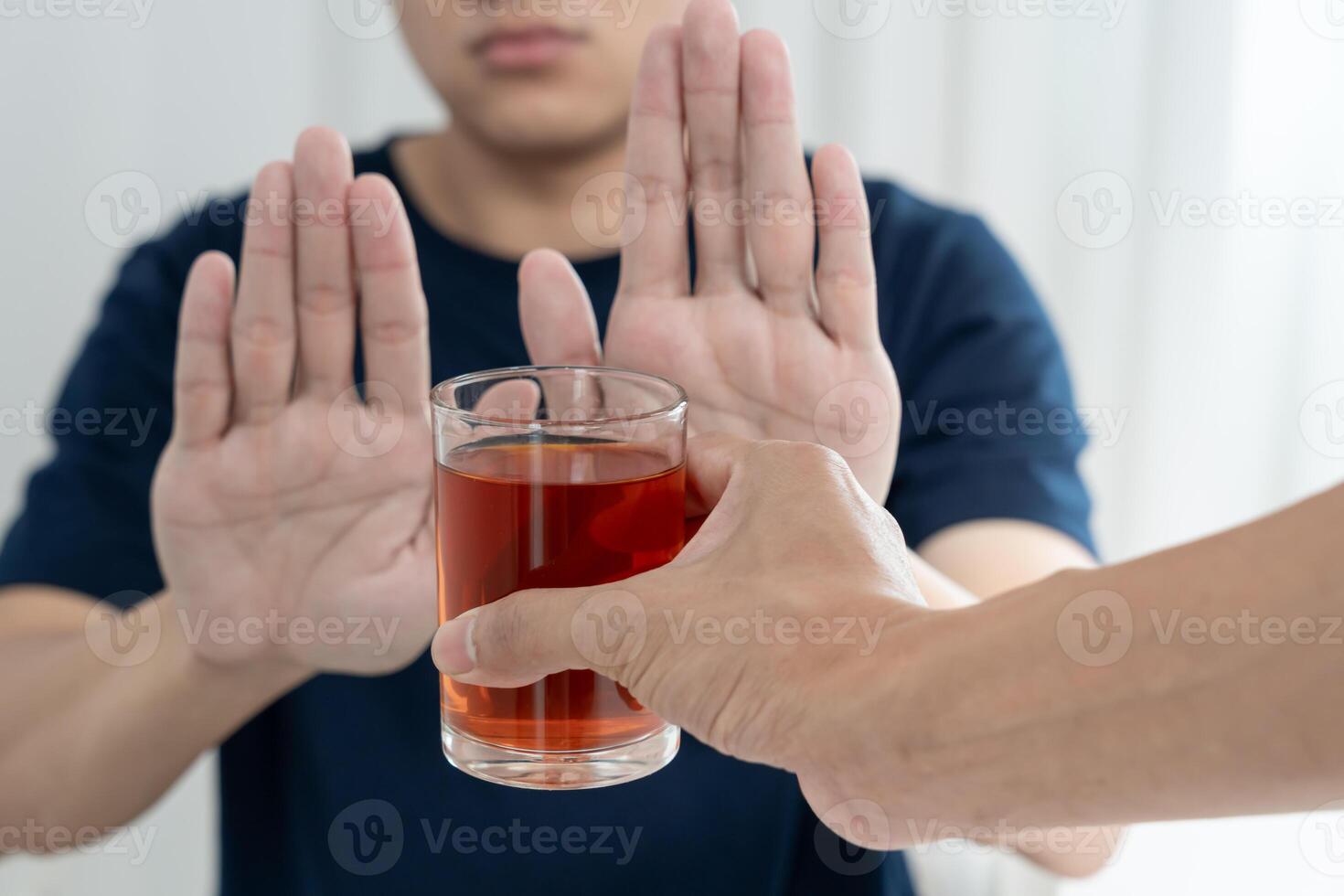 man refuses say no and avoid to drink an alcohol whiskey , stopping hand sign male, alcoholism treatment, alcohol addiction, quit booze, Stop Drinking Alcohol. Refuse Glass liquor, unhealthy, reject photo