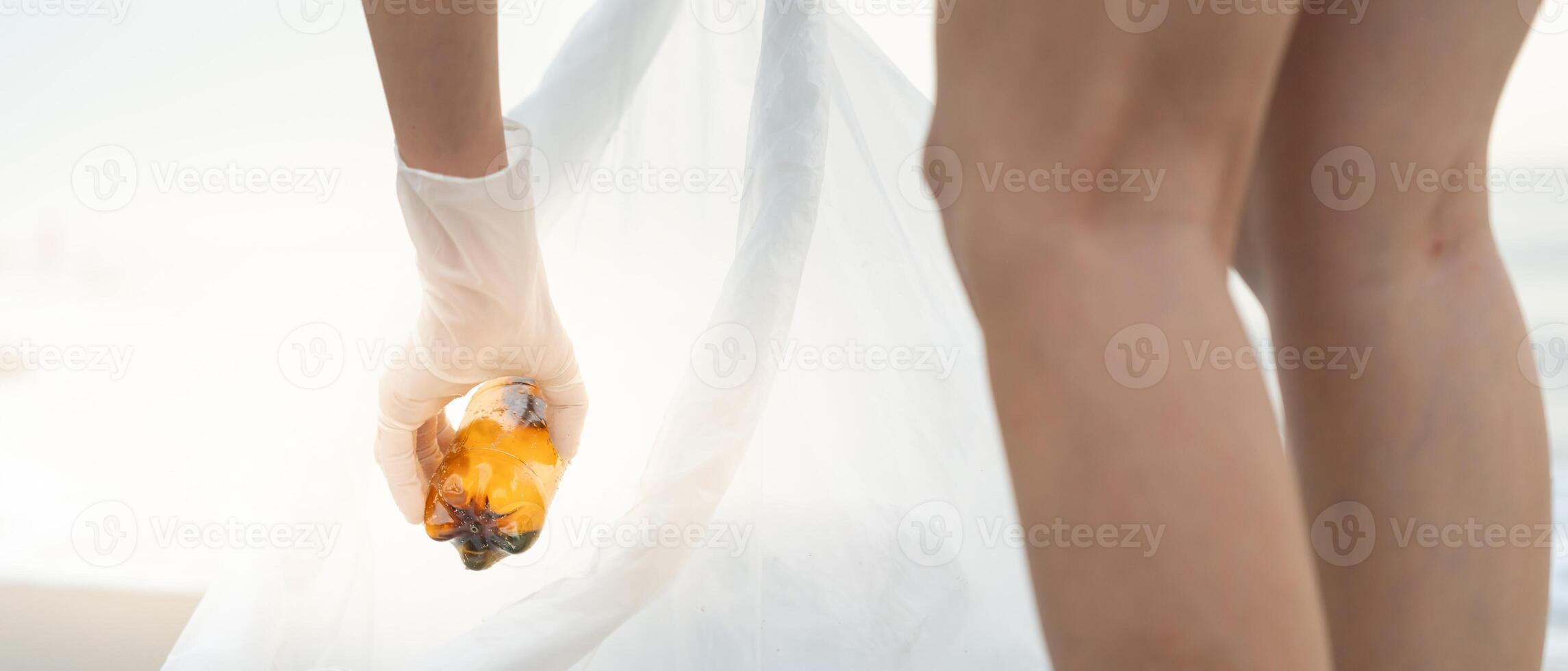 Save water. Volunteer pick up trash garbage at the beach and plastic bottles are difficult decompose prevent harm aquatic life. Earth, Environment, Greening planet, reduce global warming, Save world photo