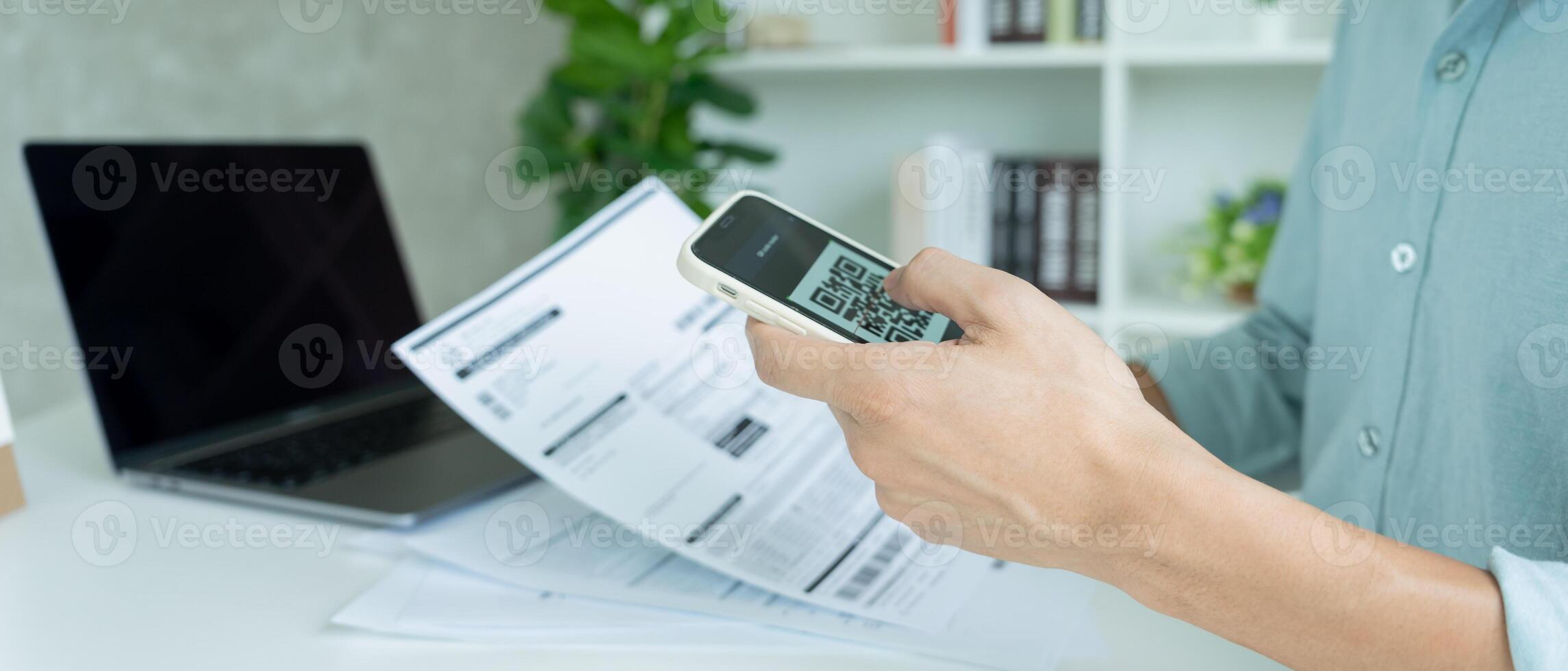 business man use phone to scan barcode or QR codes to pay credit card bill after receiving document invoice online. payment, receive, paying electricity, digital payments without money, technology photo