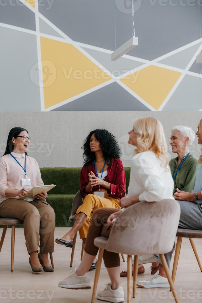 Mature women communicating and smiling while visiting group training class photo