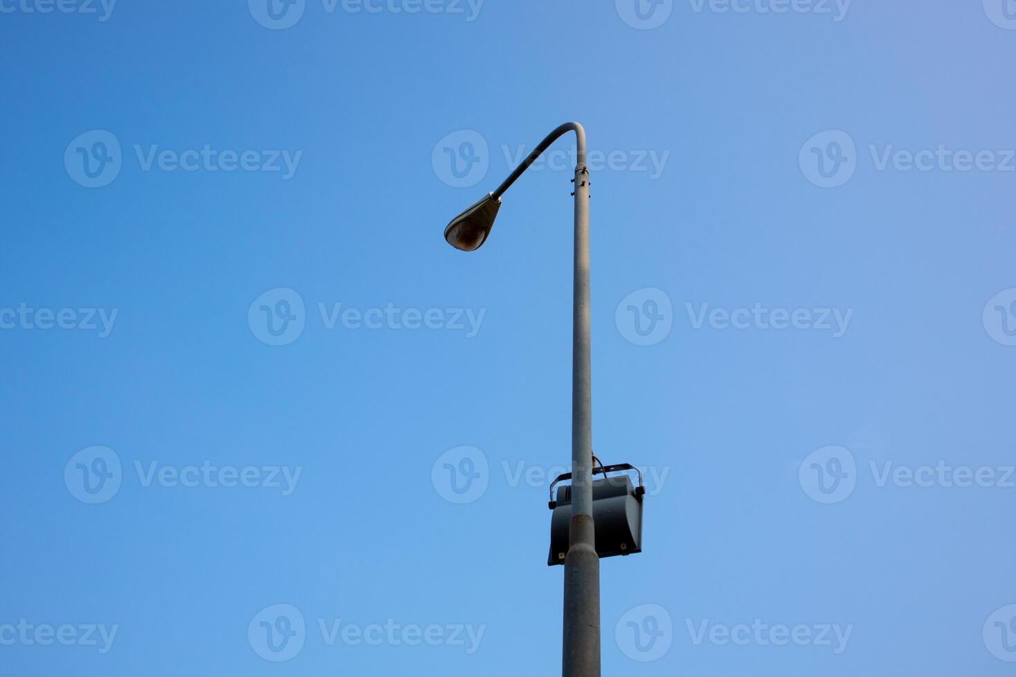Photo of lights pole under clear blue sky in the morning.