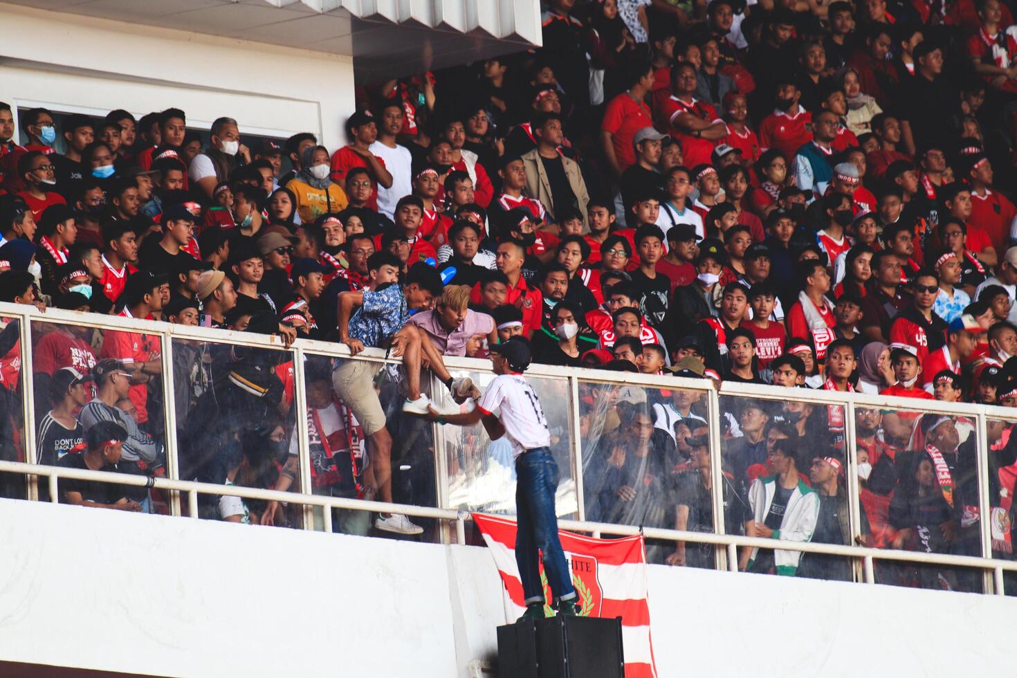 Jakarta, Indonesia - 22 Dec 2022, Fans of Indonesia national team doing dangerous stuff in the Gelora Bung Karno Stadium photo
