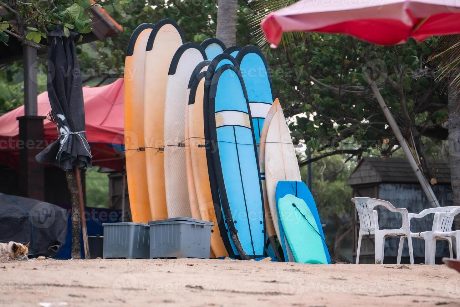 A pile of surfboards on Kuta Beach, Bali, which are available for rent. photo