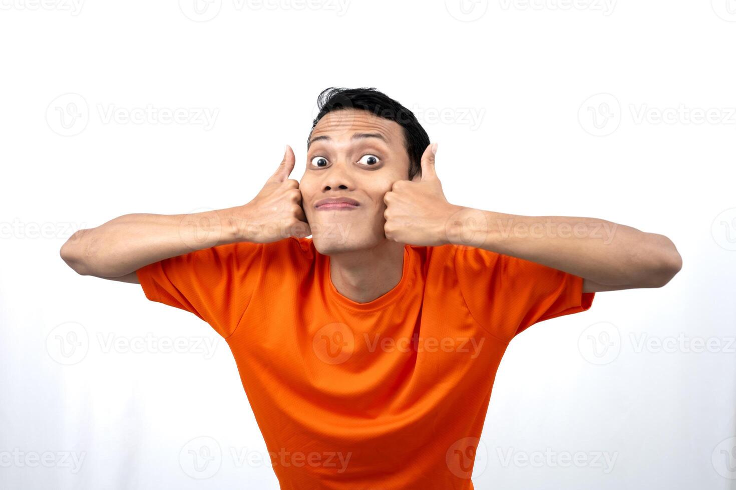 Portrait of a young Asian man wearing an orange t-shirt giving a thumbs up, okay, agree sign. isolated on white background. photo