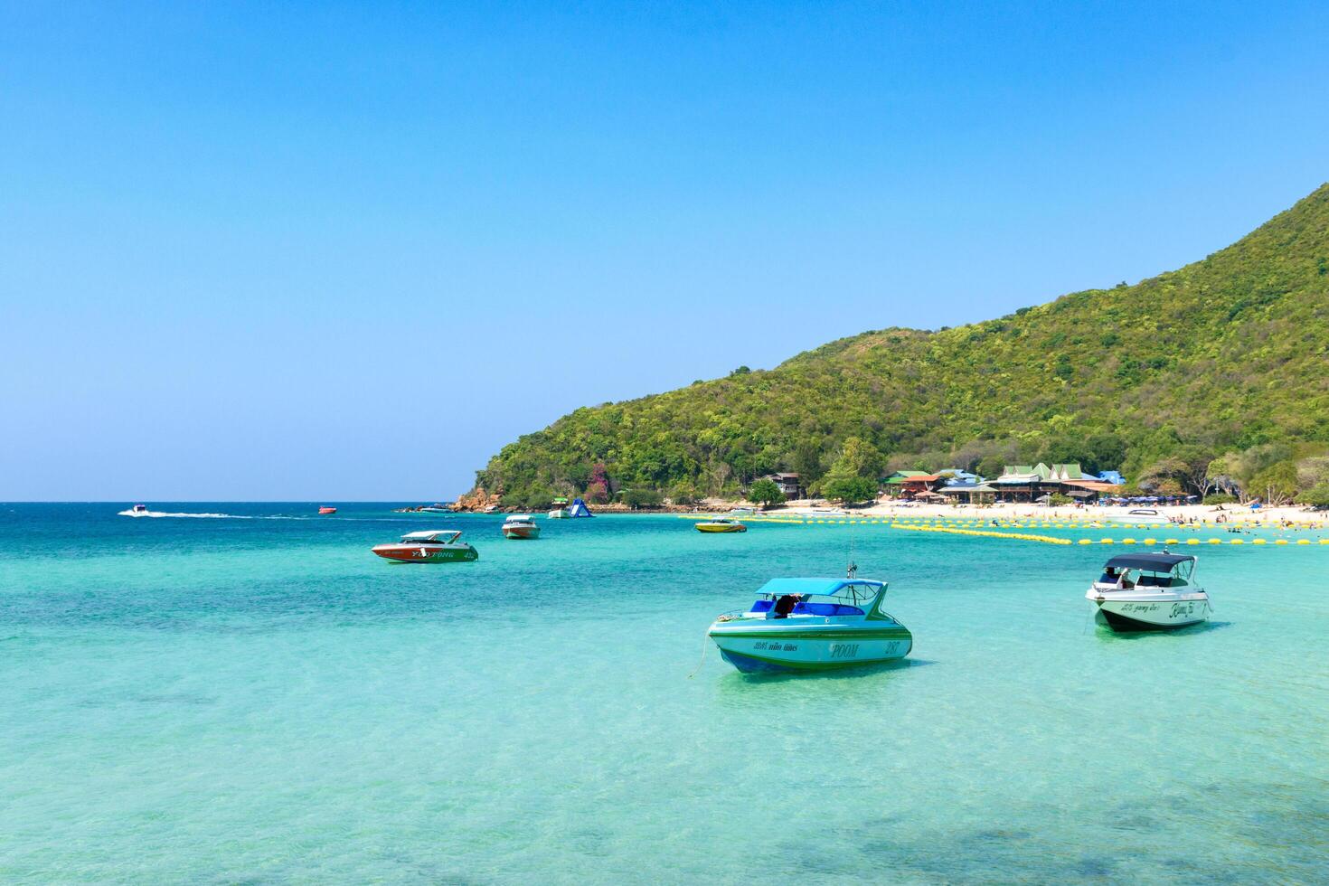 Pattaya, Thailand - March 7, 2024, Landscape of a Tropical beach and Blue sea at Koh Larn island. Group of Tourist or Traveler on the beach. Vacation, Summer, Holiday, Speedboat, Ship, Activity. photo
