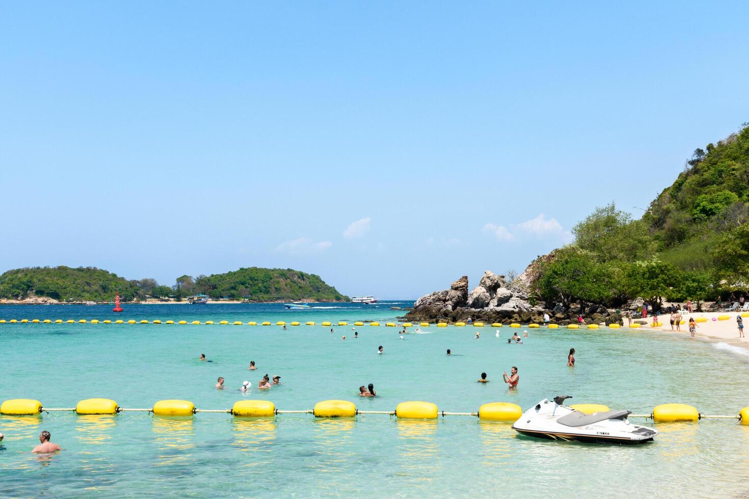 Pattaya, Thailand - March 7, 2024, Landscape of a Tropical beach and Blue sea on Koh Larn island. Group of Tourist or Traveler or many people on the beach. Vacation, Summer, Holiday, Nature, Relax. photo