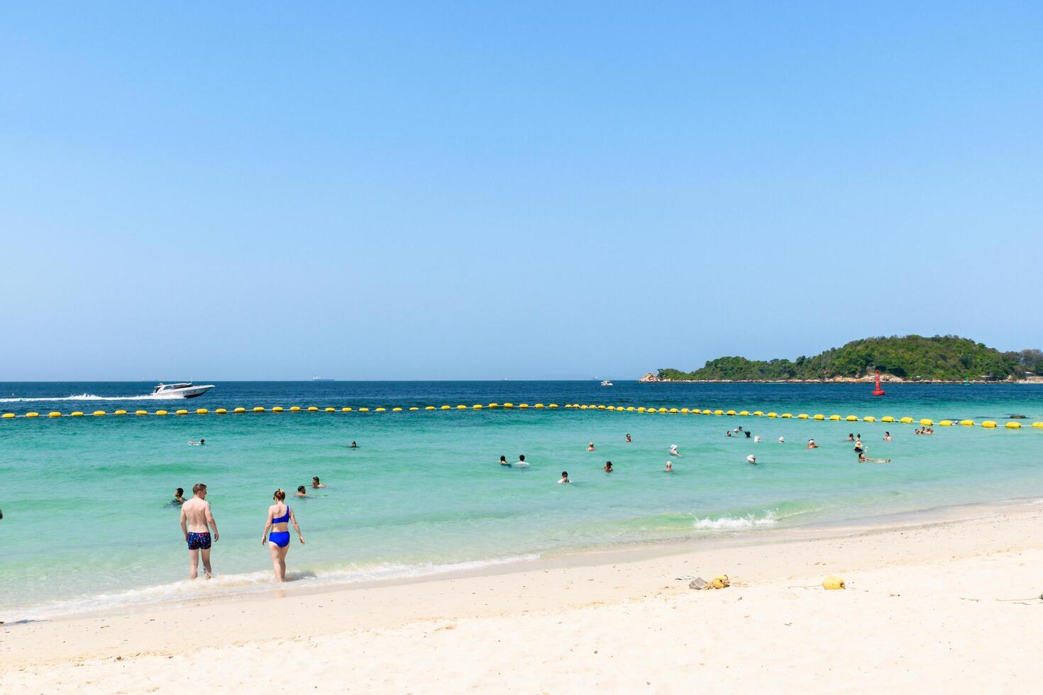 Pattaya, Thailand - March 7, 2024, Landscape of a Tropical beach and Blue sea on Koh Larn island. Group of Tourist or Traveler or many people on the beach. Vacation, Summer, Holiday, Nature, Relax. photo