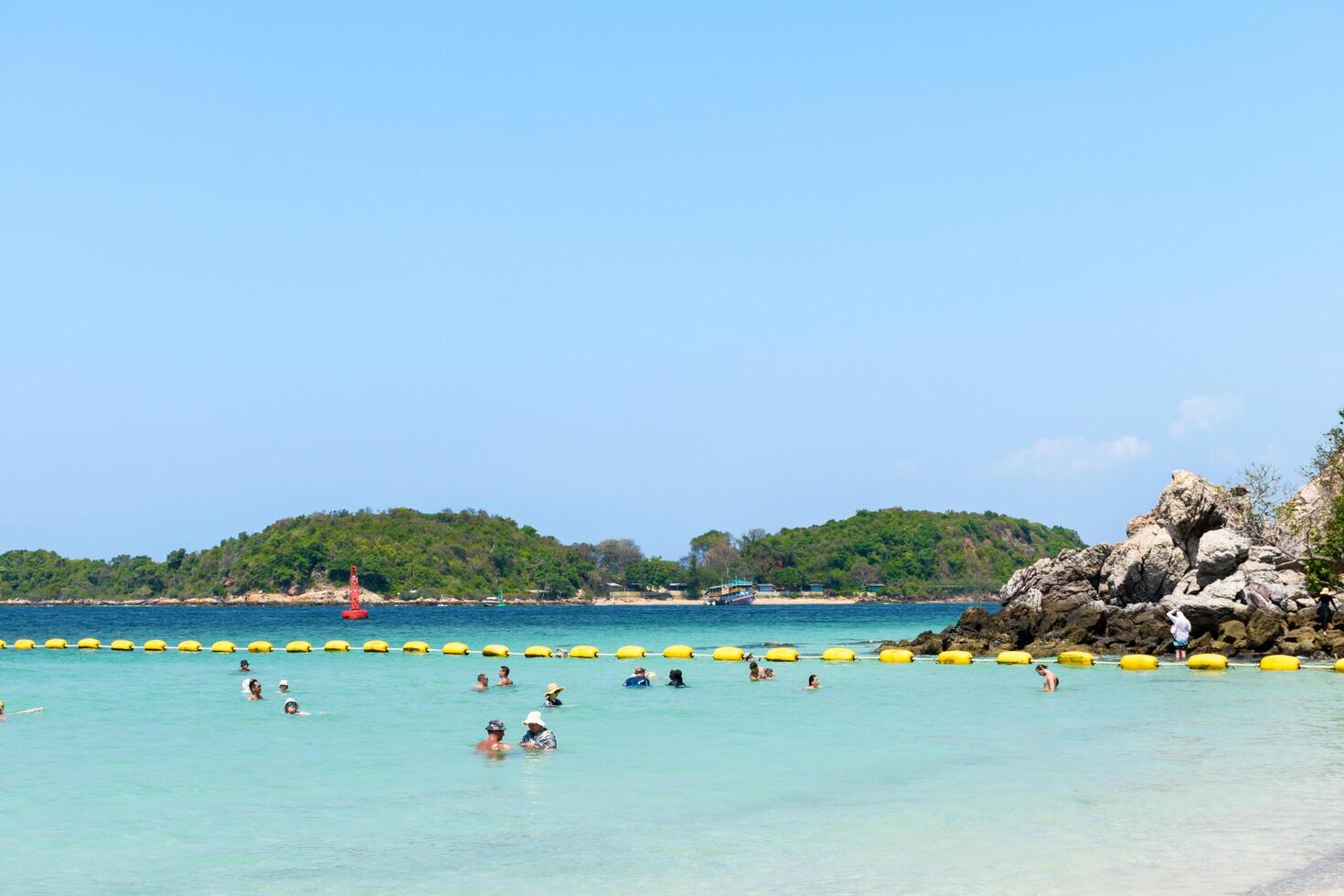 Pattaya, Thailand - March 7, 2024, Landscape of a Tropical beach and Blue sea on Koh Larn island. Group of Tourist or Traveler or many people on the beach. Vacation, Summer, Holiday, Nature, Relax. photo