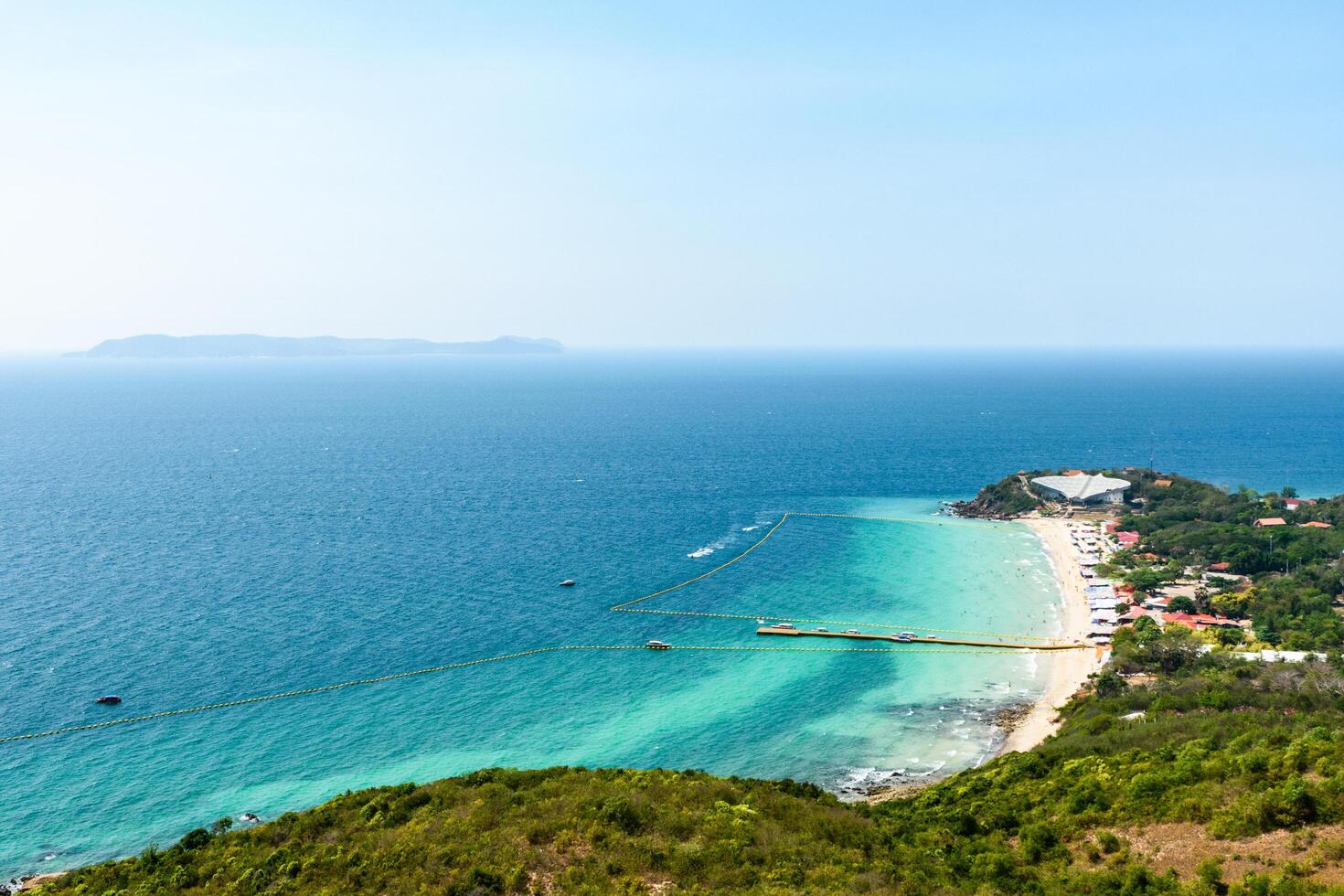 Pattaya, Thailand - March 7, 2024, Landscape of a Tropical beach and Blue sea at Koh Larn island. Group of Tourist or Traveler on the beach. Top view, Vacation, Summer, Holiday, Nature, Relax. photo