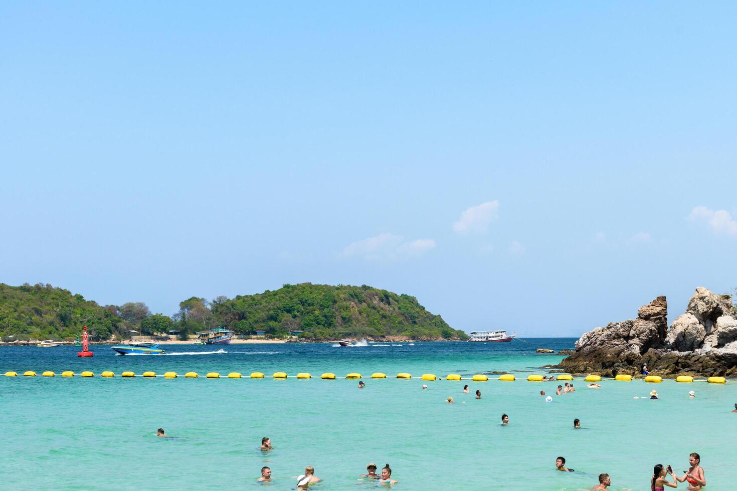 Pattaya, Thailand - March 7, 2024, Landscape of a Tropical beach and Blue sea on Koh Larn island. Group of Tourist or Traveler or many people on the beach. Vacation, Summer, Holiday, Nature, Relax. photo
