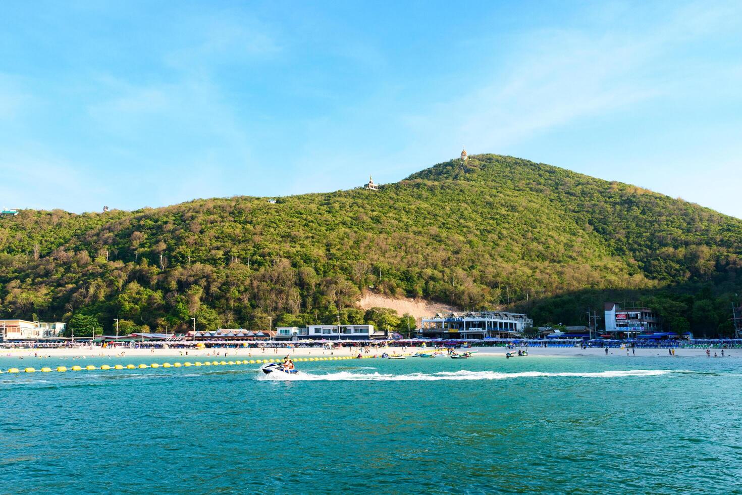 Pattaya, Thailand - March 7, 2024, Landscape of a Tropical beach and Blue sea at Koh Larn island. Group of Tourist or Traveler on the beach. Vacation, Summer, Holiday, Nature, Relax, Activity. photo