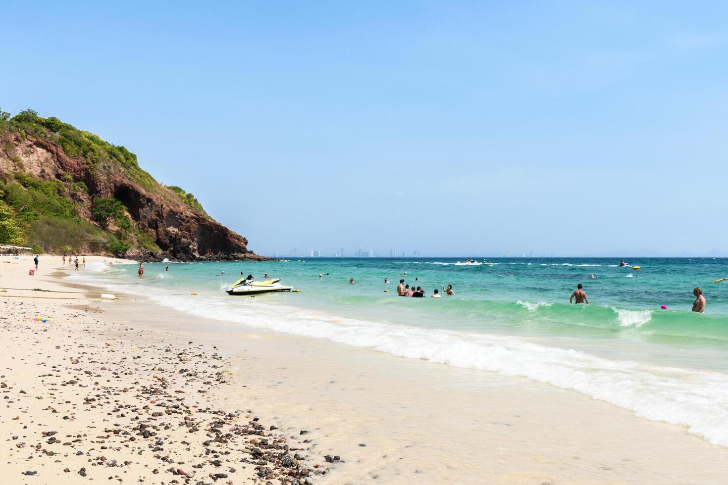 Pattaya, Thailand - March 7, 2024, Landscape of a Tropical beach and Blue sea on Koh Larn island. Group of Tourist or Traveler or many people on the beach. Vacation, Summer, Holiday, Nature, Relax. photo