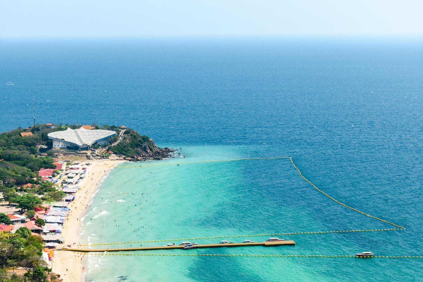 Pattaya, Thailand - March 7, 2024, Landscape of a Tropical beach and Blue sea at Koh Larn island. Group of Tourist or Traveler on the beach. Top view, Vacation, Summer, Holiday, Nature, Relax. photo